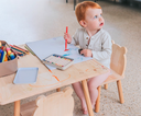 picture of kid in diaper scribbling at school