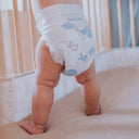 Cute baby bottom in a woosh diaper size 4